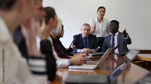 Two mature male executive board members dressed in formal suits holding corporate team meeting in conference hall