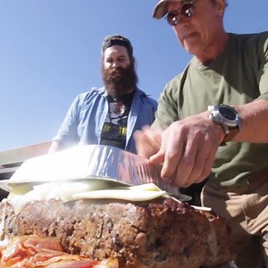 Arnold Schwarzenegger's "Steak and Egger" Sandwich Is Nearly 80,000 Calories And Cooked on a Tank—Watch Now!