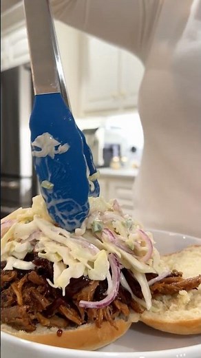 Pulled pork bbq sandwich with apple cider jalapeño slaw
