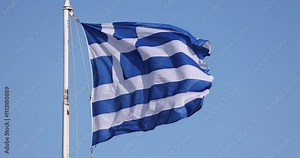Slow motion video of the Greek flag waving in Athens over the Acropolis Stock Video