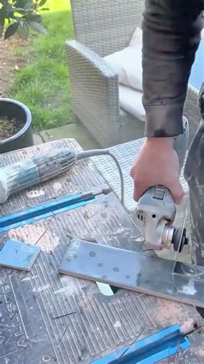 Cutting ceramic tile using an angle grinder to shape edges accurately for installation work final