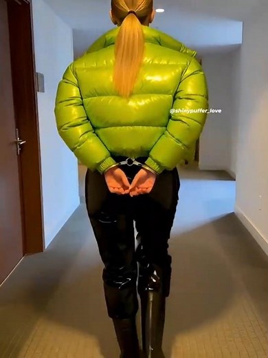 Handcuffed, in puffer jacket, puffy pants, and rubber boots