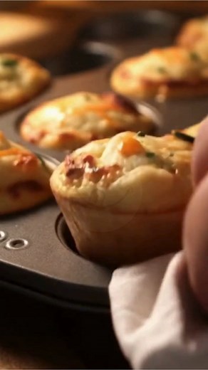 Cheesy Mashed Potato Muffins A warm, crispy-edged, cheesy little comfort bite—perfect for using up leftover mashed potatoes and serving as a fun side or snack. What You'll Need Cold leftover mashed potatoes (3 cups) Egg, large (1) Shredded cheddar cheese, divided (1 cup) Fresh chives, chopped, divided (3 tbsp) Salt and pepper, to taste Cooking spray or butter for greasing How to Make It 1. Preheat oven to 375°F and grease a non-stick muffin tin. 2. In a large bowl, mix mashed potatoes, egg, 3/4 