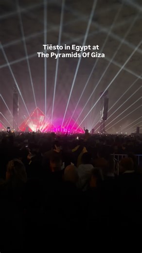 Tiësto live at the Pyramids of Giza, with the night fully underway and the crowd locked in. The Giza Plateau transformed into an open air dance floor as the Dutch DJ and producer delivered a high energy set framed by the illuminated pyramids behind him. From the opening moments to peak time, the atmosphere continued to build, with large scale production, lighting, and sound designed specifically for the site. A mix of classic Tiësto records and newer tracks carried the night, as thousands gather