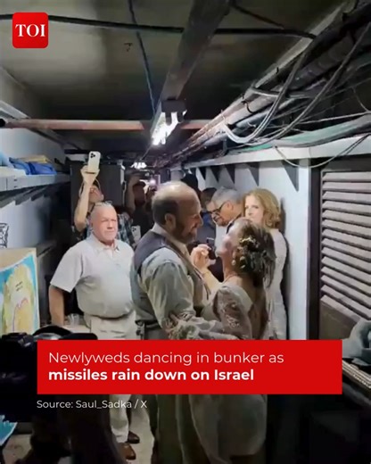 A heartwarming and emotional video has emerged, highlighting a freshly married couple, Kristirae and Shawn Gibson, ending up dancing in an underground hideout in #Jerusalem at the same time as missiles bombarded #Israel Know more http://toi.in/5823Ba | The Times of India