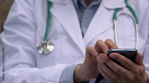 Detailed view of a female doctor's hand using a tablet to schedule patient appointments