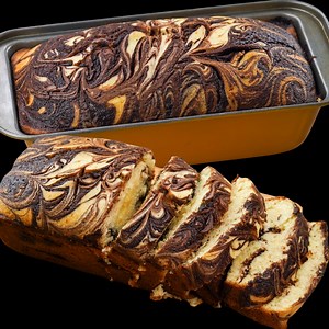 Marble Loaf Cake | Delightful and Soft Marble Cake | Beautifully Designed Marble Cake | N'Oven This Marble Loaf Cake is a perfect blend of rich chocolate and classic vanilla — beautifully swirled, soft, and bakery-style delicious! With its eye-catching design and moist texture, this cake is perfect for tea-time, dessert, or gifting. And the best part? It’s super easy to make at home! Marble Loaf Cake | Delightful and Soft Marble Cake | Beautifully Designed Marble Cake | N'Oven What You’ll Love: 