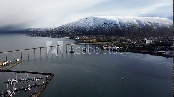 Drone shot of a bridge leading out of the small city of Tromso in Norway.