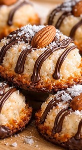 🥥 Almond Joy Coconut Macaroon Cookies (Flourless) Ingredients 3 cups sweetened shredded coconut ¾ cup sweetened condensed milk 1 tsp vanilla extract ¼ tsp salt ¾ cup chocolate chips Whole almonds (one per cookie) Dark chocolate, melted for drizzle Extra shredded coconut Instructions 1. Preheat oven to 325°F (165°C). 2. Mix coconut, condensed milk, vanilla, salt, and chocolate chips. 3. Scoop mounds onto lined baking sheet, lightly flatten. 4. Press an extra chocolate chips and almond into each