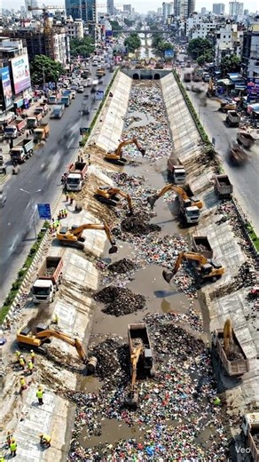 Cinematic timelapse of a busy city center with a dirty garbage-filled drainage canal (nala) in the