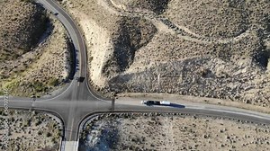 Get an aerial view of a pickup truck towing a carhauler in this review and inspection video. Watch as the semi truck makes a pitstop at a gas station, showcasing its capabilities on the road