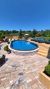 Now this is a backyard built for serious relaxation! 😍☀️ This customer’s above ground pool from The Pool Factory is surrounded by a sleek stone wall base, rich wood accents, and a full paver patio that looks straight out of a resort. 💦🪵🌴 Paired with comfy blue loungers and cozy shade, it’s the ultimate staycation spot! 💡 Pool Tip: Stone or paver bases around your pool not only add style, they also improve drainage and reduce splashing mess! 🌿 Backyard Tip: Add matching lounge chairs and pl