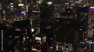 Night time view of Austin's skyline, with illuminated skyscrapers and vibrant city life from above in a serene aerial perspective