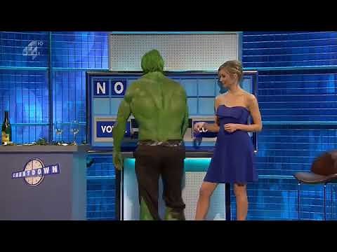 Rachel Riley crossing legs in blue dress