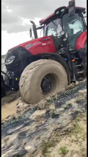 Case IH 300 Tractor in Muddy Terrain