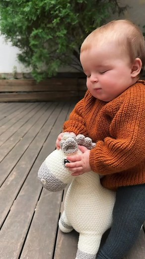 Young Child Riding a Toy Horse Outdoors