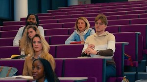 Diverse student group sitting attentively during university lecture, recording dynamic learning moment with concentrated intellectual curiosity in slow motion