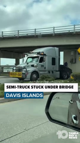 Semi-truck stuck under bridge in Tampa
