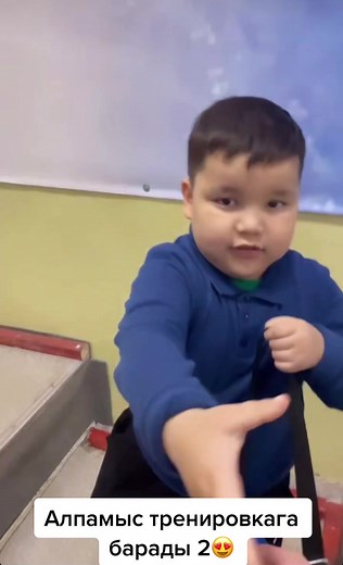 Young Child Trying on Shoes in Martial Arts Facility