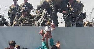 Afghans Photographed Handing Babies Over Barbed Wire To Soldiers At Airport