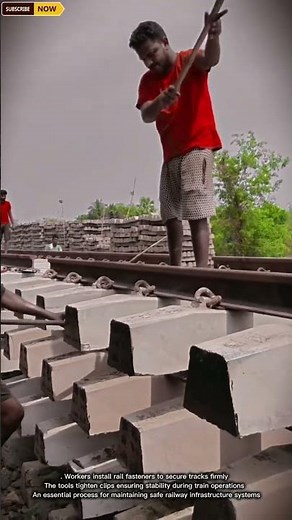Workers Installing Rail Fasteners for Secure and Stable Railway Tracks