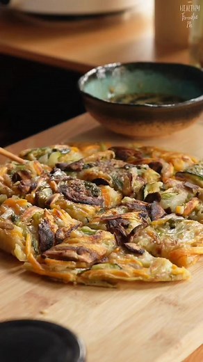 Easy at healthy Korean Vegetable Pancake Recipe Ingredients: 1 cup zuchinni 1 cup sweet potato 1 stalk scallion 1/8 cup spring onion 1 pc shiitake mushroom 1/2 white onion Batter: 3/4 cup plain flour 3/4 cup water salt Dipping sauce: 1/8 cup low sodium soy sauce 2 tsp vinegar 1 tsp sesame oil 1 tsp hot sauce (optional) toasted sesame seeds #cooking #fbreel #koreanfood #koreanpancake #vegetablepancake | Healthy Foodie PH