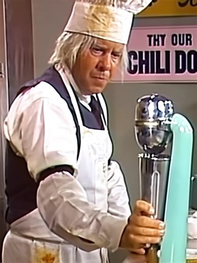 As Tim Conway slowly placed the napkin on the table and muttered, “Hot‑dog… milkshake…” in a half-asleep drawl, everyone knew lunch was about to go spectacularly wrong. Harvey Korman just wanted a simple hot‑dog and a chocolate shake, but the bumbling old vendor began asking for directions, messing everything up, and turning every little mishap into pure comedic gold. Each fumbled step, every pause, and every “mistake” became a classic hit, leaving both the audience and Harvey in stitches. This 