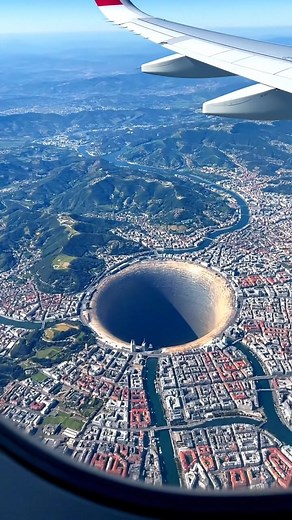 701K views · 270 reactions | High above Bilbao, Spain, a massive, perfectly circular hole stretches into the ground near the edge of the city. The Basque hills and winding river surround it, the scene still, silent, and impossibly deep. #spain #fblifestyle #coldfront #winterweather #earthimpacts This content isn’t real — it’s a simulated ‘what if’ scenario created by AI for visual exploration. | Earth Impacts | Facebook