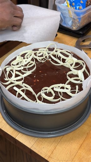 Finishing Touches | Adding white chocolate curls to a triple chocolate mousse cake for a little birthday celebration later. | Wayne Johnson