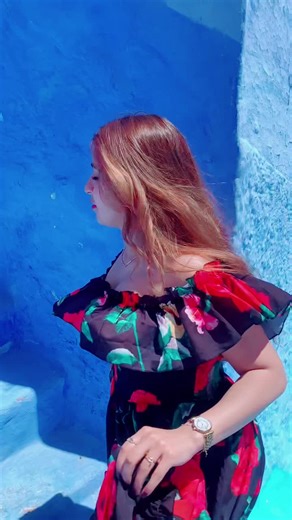 Woman in Floral Dress Ascending Colorful Stairs