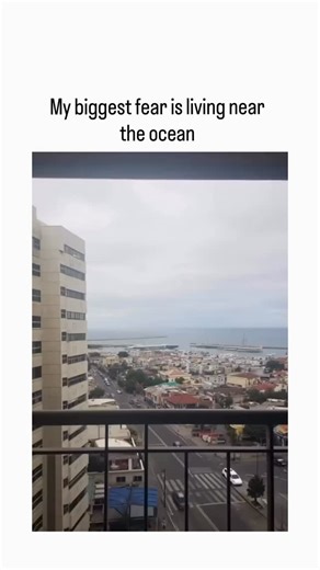 globalreel.lio on Instagram: "The post features a 10-second video from a high-rise balcony overlooking a coastal city, depicting an accelerated ocean surge flooding streets and buildings under overcast skies. Captioned “My biggest fear is living near the ocean,” it taps into anxieties about coastal vulnerabilities, echoing real December 2025 events like atmospheric river floods in Washington state. Replies blend shock (“Oh my God”), humor (“As long as I can have fun”), and skepticism (“AI or not