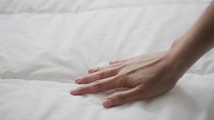 Download Hand Touching The Bed for free
