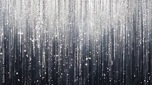 Glistening vertical lines of silver glitter fall gracefully, forming a mesmerizing display of light and movement against a dark gray backdrop
