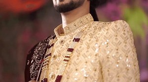 Indian bride and groom treasured moments and wearing red Sharara, sharwani