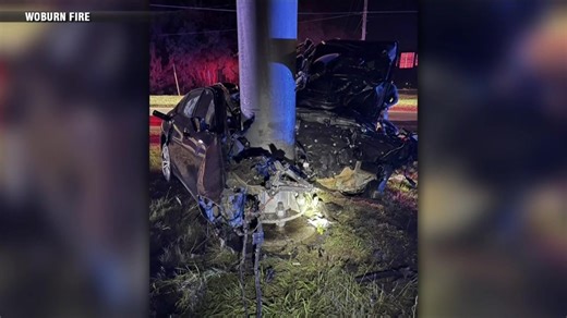 Car hits pole, catches on fire in Woburn