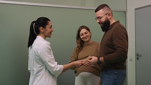 Doctor giving envelope to a couple | Free Stock Video Footage