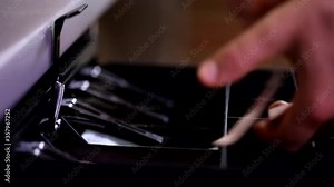 Close up shot of man cashier hand opening cash register drawer with key taking counting money banknotes fast