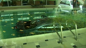 Man crashes car through LA Fitness center wall, lands in swimming pool