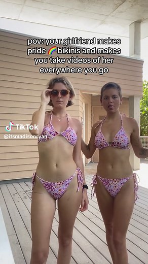 Lesbian Couple Kisses in Colorful Bikinis at the Beach