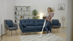 Beautiful young woman dancing while cleaning living room with vacuum cleaner