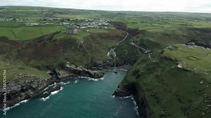Aerial View Of Peninsula Of Tintagel Island With Camelot Castle Hotel, Tintagel Castle, And Village In Cornwall, United Kingdom.