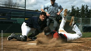 Baseball player slides into home plate, slow motion