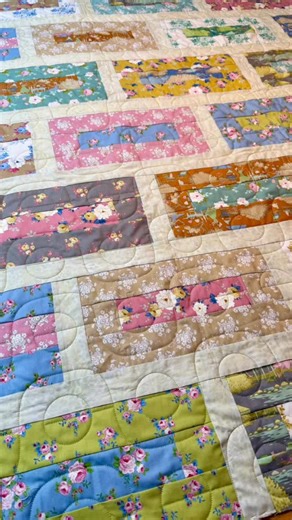Terri Neil on Instagram: "This rectangle quilt is an easy one to put together with minimal piecing. Anne used Tilda fabric, chose ‘Celery’ colored thread from @habanddash, and used a more modern panto than usual - ‘Brass Tax’ from @sewshabbyquilting. Quilts often are big projects with big decisions - the pattern, fabric pull, cutting, piecing, longarming. But it’s worthwhile in the end. Anne is donating this beauty to a good cause. #quiltingrubies #longarmservices #modernpantograph #easyquilt #q