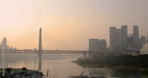Sunset view of Jialing River (left) joining Yangtze River with Qianshimen Bridge, Grand Theater and Chaotianmen Changjiang Bridge in Chongqing, China.