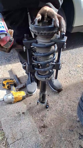 How to get the tension off the spring to remove it from the strut. Pretty easy if you have the right tool. #automotive #mechanic #repair | Josh Woodard