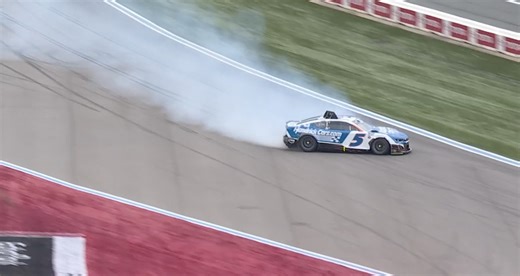 Larson goes for spin through the grass while leading Coca-Cola 600