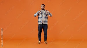 Confused man rubs hands with excited expression on face