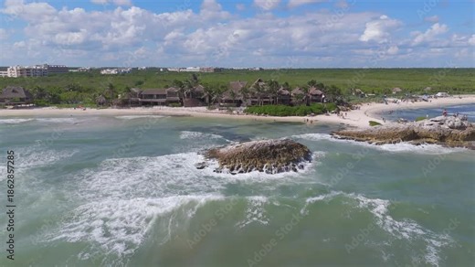 Scenic aerial of Tulum’s beach area, highlighting peaceful ocean waters and lively beachfront clubs.