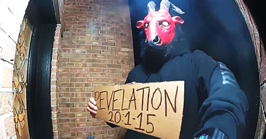Man wearing devilish mask, holding sign with apocalyptic bible verse seen lurking around U.S. home