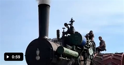 Steam traction engine pulling a 44 bottom plow. - Video